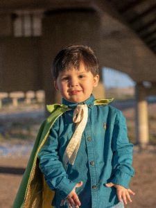 Niño sonriente con capa